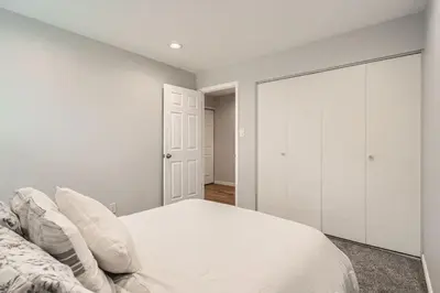 a white bedroom with a bed and a closet at Littleton DTC updated GEM with Hot Tub! in Centennial
