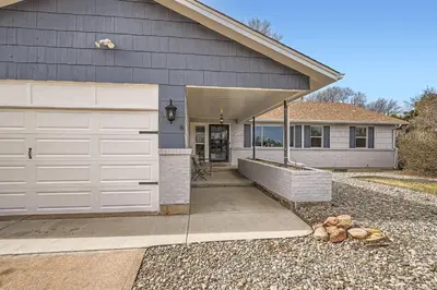 a house with a white garage door and a driveway at Littleton DTC updated GEM with Hot Tub! in Centennial