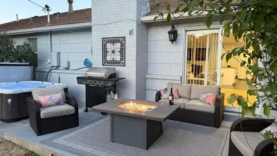 a backyard with a barbecue and a couch and a table at Littleton DTC updated GEM with Hot Tub! in Centennial