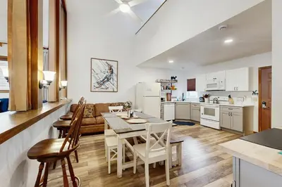 a kitchen and living room with a table and chairs at Mountainside 049 in Granby