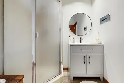 a bathroom with a shower and a sink and a mirror at Mountainside 049 in Granby