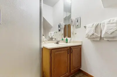 a bathroom with a sink and a mirror at Mountainside 049 in Granby