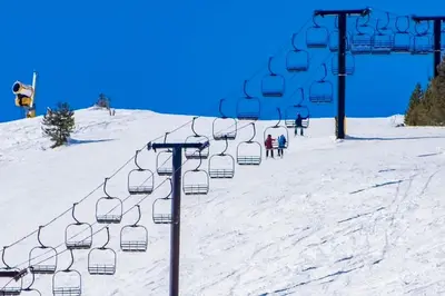 a ski lift on a snow covered ski slope at Mountainside 049 in Granby