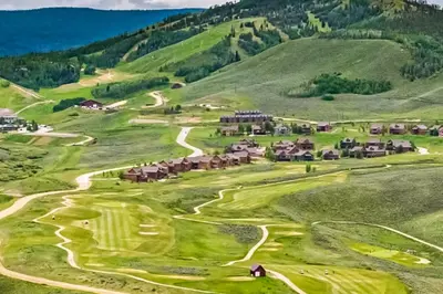 an aerial view of a golf course with mountains in the background at Mountainside 049 in Granby