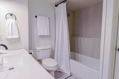 a white bathroom with a toilet and a shower at New cozy Fall foothill retreat in Boulder in Boulder