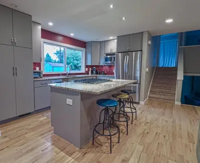 a kitchen with a large island with bar stools at New cozy Fall foothill retreat in Boulder in Boulder