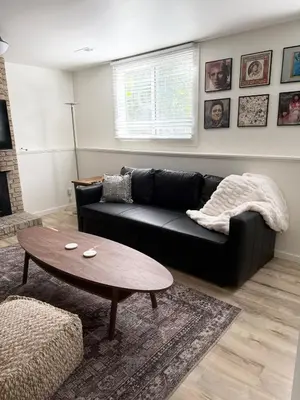 a living room with a black couch and a coffee table at New cozy Fall foothill retreat in Boulder in Boulder