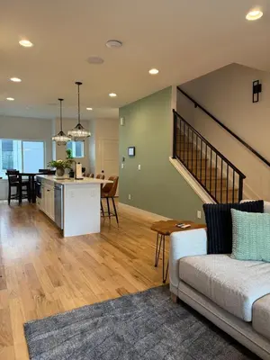 a living room with a couch and a kitchen at Cozy 3 Bedroom Denver Home by Mile High Stadium and Downtown! in Denver