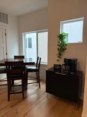 a dining room with a table and chairs and windows at Cozy 3 Bedroom Denver Home by Mile High Stadium and Downtown! in Denver