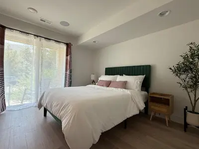 a bedroom with a large bed and a window at Cozy 3 Bedroom Denver Home by Mile High Stadium and Downtown! in Denver