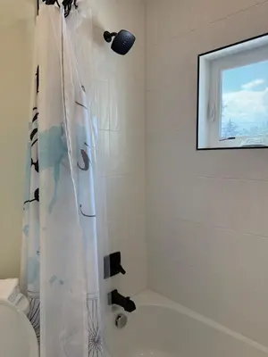 a bathroom with a shower with a shower curtain at Cozy 3 Bedroom Denver Home by Mile High Stadium and Downtown! in Denver