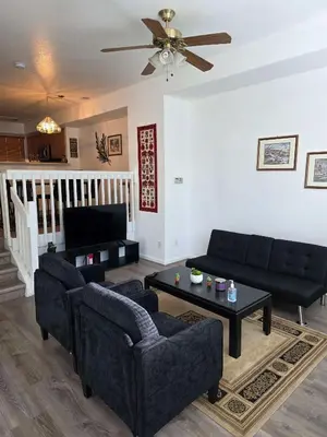 a living room with two couches and a table at Cozy near airport vacation home Brighton in Brighton