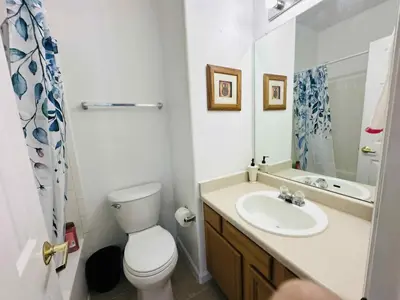 a bathroom with a white toilet and a sink at Cozy near airport vacation home Brighton in Brighton