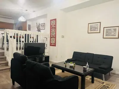 a living room with two couches and a coffee table at Cozy near airport vacation home Brighton in Brighton