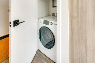 a washer and dryer sitting in a room at Walk to Ski Shuttles and Stores! Modern Frisco Unit in Frisco