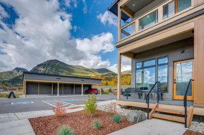 a home with a view of the mountains at Walk to Ski Shuttles and Stores! Modern Frisco Unit in Frisco