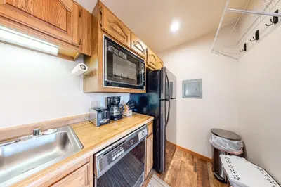 a kitchen with a sink and a refrigerator at Timber Ridge 217 in Silverthorne