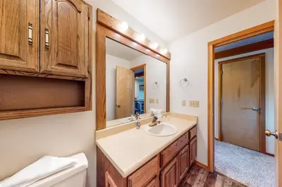 a bathroom with a sink and a toilet and a mirror at Timber Ridge 217 in Silverthorne