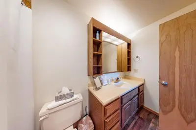 a bathroom with a sink and a toilet and a mirror at Timber Ridge 217 in Silverthorne