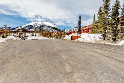 an empty road with a snow covered mountain in the background at Timber Ridge 217 in Silverthorne