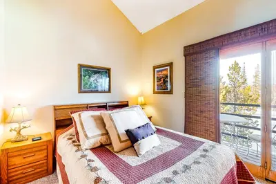 a bedroom with a bed and a large window at Timber Ridge 91226 in Silverthorne