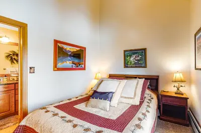 a bedroom with a bed and two pictures on the wall at Timber Ridge 91226 in Silverthorne