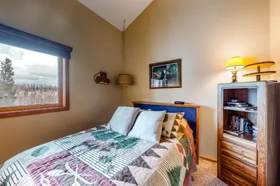 a bedroom with a bed and a window at Timber Ridge 91226 in Silverthorne