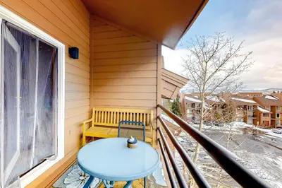 a balcony with a blue table and a window at Timber Ridge 91226 in Silverthorne