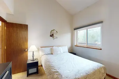 a small bedroom with a bed and a window at Buffalo Ridge C302 in Silverthorne