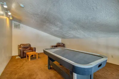 a ping pong table in a room with chairs at Buffalo Ridge C302 in Silverthorne