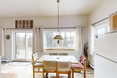 a dining room with a table and chairs and a refrigerator at Buffalo Ridge C101 in Silverthorne