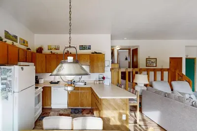 a kitchen with wooden cabinets and a white refrigerator at Buffalo Ridge C101 in Silverthorne