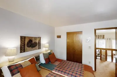 a bedroom with a bed and a couch in a room at Buffalo Ridge C101 in Silverthorne