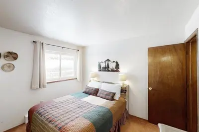 a small bedroom with a bed and a window at Buffalo Ridge C101 in Silverthorne