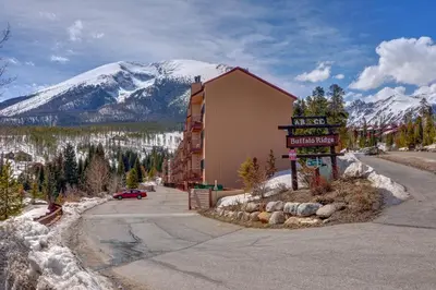 a sign in front of a building with a snow covered mountain at Buffalo Ridge C101 in Silverthorne