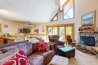 a living room with a couch and a fireplace at Tenderfoot Lodge 2663 in Keystone
