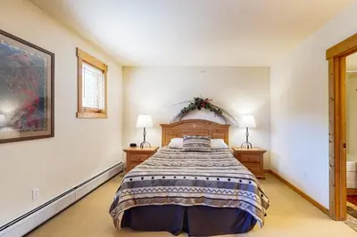 a bedroom with a large bed and two lamps at Tenderfoot Lodge 2663 in Keystone