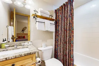 a bathroom with a toilet and a sink and a shower at Tenderfoot Lodge 2663 in Keystone