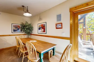 a dining room with a wooden table and chairs at Tenderfoot Lodge 2663 in Keystone