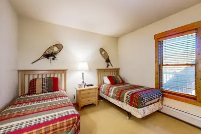 a bedroom with two beds and a window at Tenderfoot Lodge 2663 in Keystone