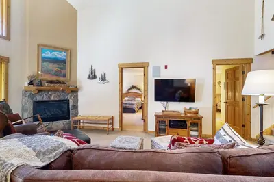 a living room with a couch and a fireplace at Tenderfoot Lodge 2663 in Keystone