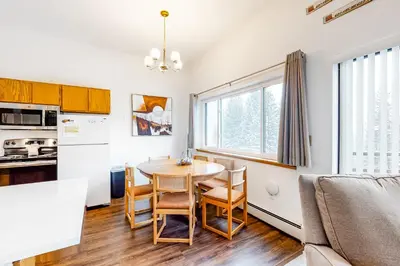 a kitchen and living room with a table and chairs at Buffalo Ridge C102 in Silverthorne