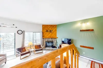 a living room with a staircase and a fireplace at Buffalo Ridge C102 in Silverthorne