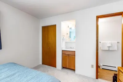 a bedroom with a bed and a sink and a mirror at Buffalo Ridge C102 in Silverthorne