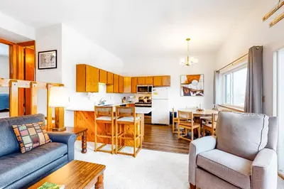 a kitchen and living room with a couch and a table at Buffalo Ridge C102 in Silverthorne