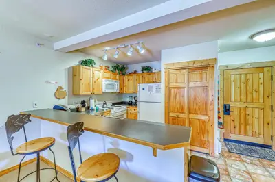 a kitchen with wooden cabinets and a counter top at Tenderfoot Lodge 2664 in Keystone