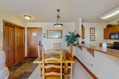 a kitchen with a wooden table in a room at Oro Grande 416 in Keystone
