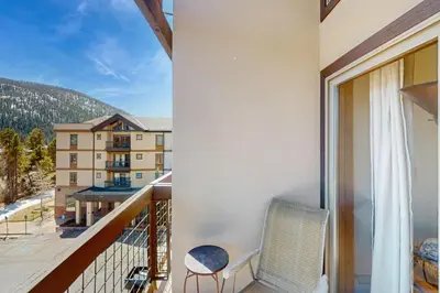 a balcony with a chair and a view of a building at Oro Grande 416 in Keystone