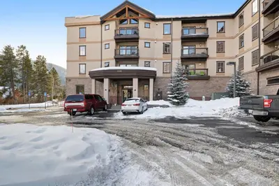 a building with cars parked in a parking lot at Oro Grande 416 in Keystone
