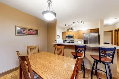 a kitchen and dining room with a wooden table and chairs at Oro Grande 216 in Keystone